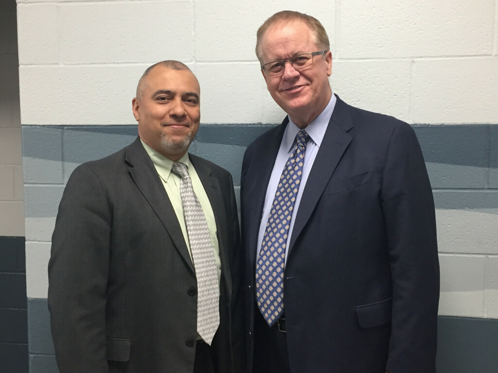 Photo on May 12, 2018 Miguel Crespo, President of SDA Church, NY Conference, and Terry Newmyer in Union Springs, NY at dedication of the recently re-built Newmyer Hall administration building, following the tragic fire that destroyed the building two years earlier. Newmyer Hall is named in memory of Clyde Newmyer, former principal of the school. Terry represented his father and the Newmyer family at the celebration. 