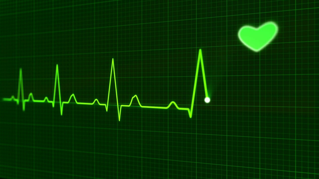 green EKG line with heart
